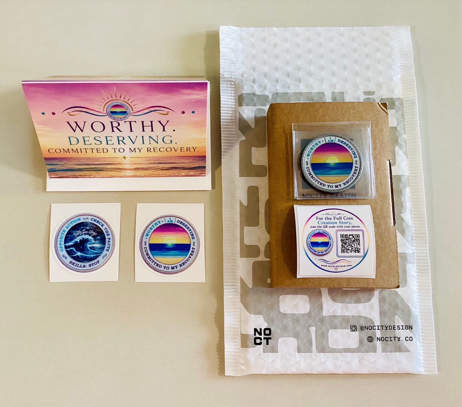 My Recovery Coin package with the coin, recovery card, stickers, QR card, and protective mailer